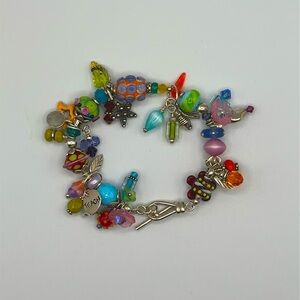 Artisan hand blown glass beads and sterling silver charms gallery bracelet.